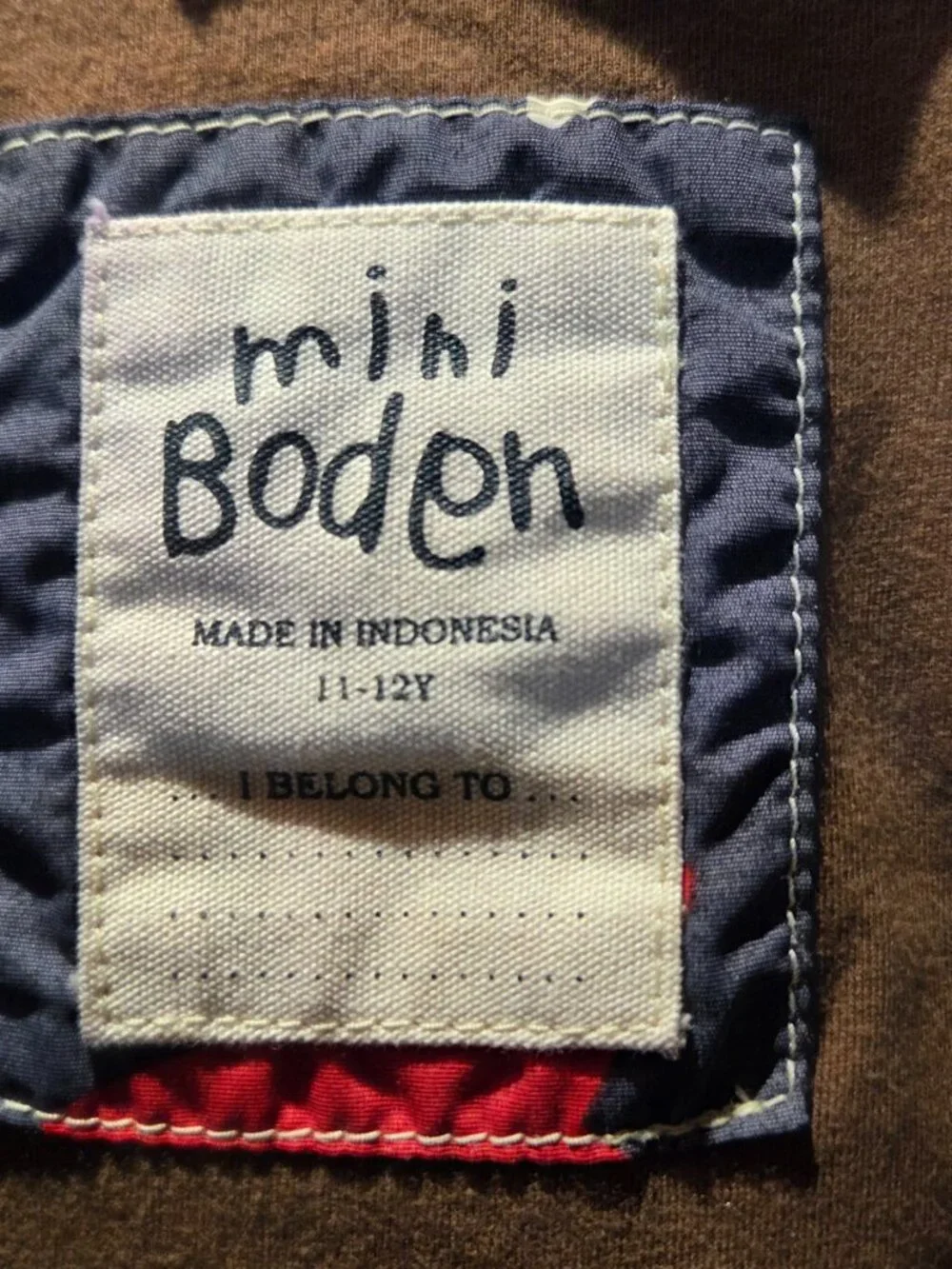 rain jacket features a navy blue background covered in a bold red and white star